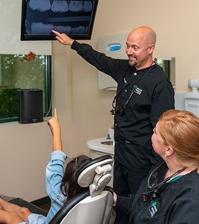 Dentist showing patient digital x-rays