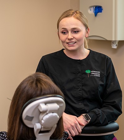 Dentist and patient looking at smile model