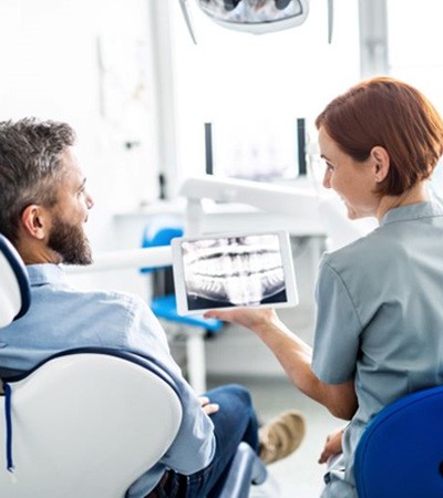 Patient and dentist reviewing X-ray together