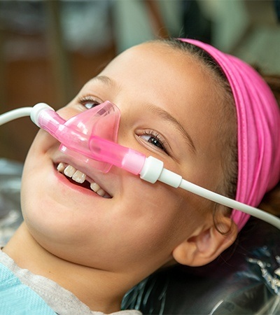 Young girl receiving nitrous oxide dental sedation for kids