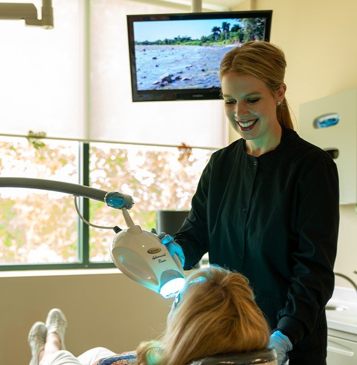 Dental team member offering cosmetic dentistry treatment
