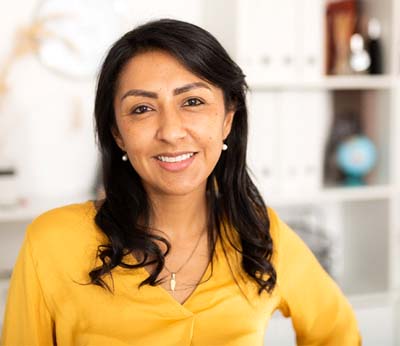 woman smiling after learning how to make cosmetic dentist in Bellbrook affordable