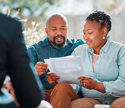 a couple looking at a dental bill