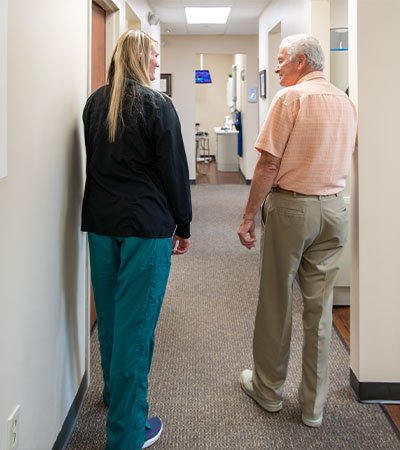 Dental team member and patient discussing cost of treating dental emergencies