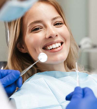 patient smiling while visiting an emergency dentist in Sugarcreek Township