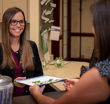Patient talking to dental team member about dental insurance coverage