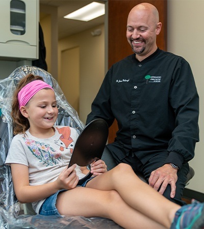 Dentist working with young patient in dental treatment room