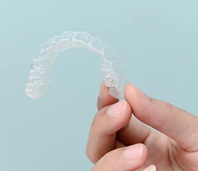 Patient holding clear aligner