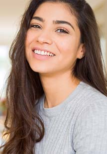 Woman smiling after getting Invisalign in Bellbrook 