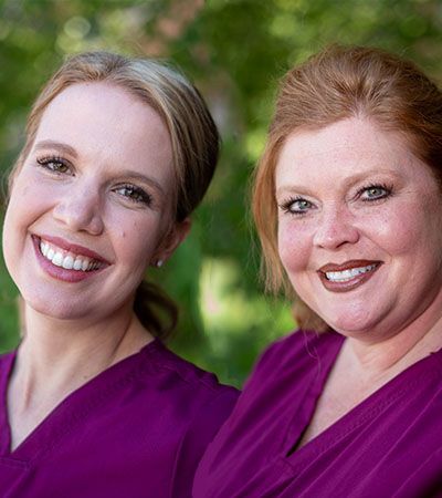 Dental team members who offer scaling and root planing smiling