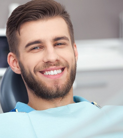 A smiling man who received effective dental care