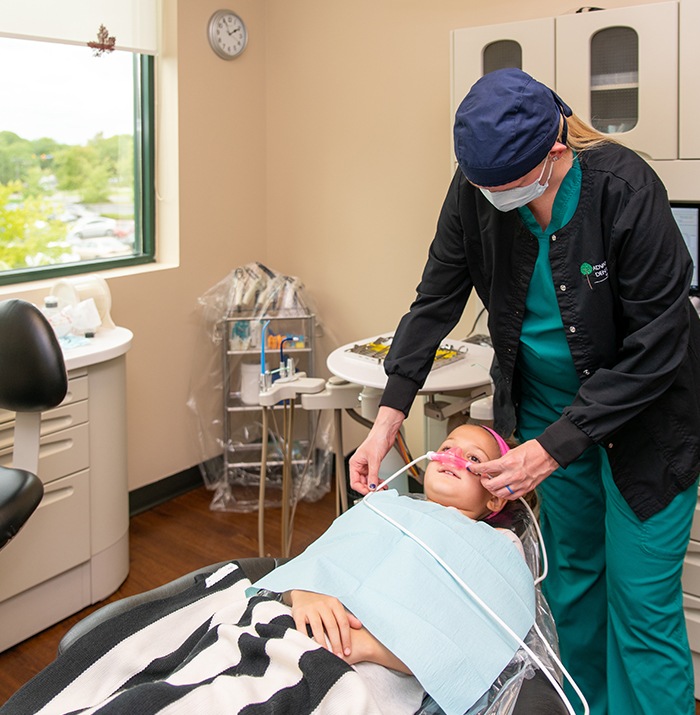 Young patient receiving nitrous oxide sedation dentistry treatment