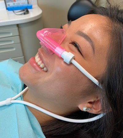 Patient with nitrous oxide dental sedation mask in place