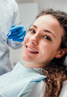 Woman smiling while getting a dental checkup
