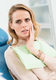 Dental team member and dentist discussing dental implant tooth replacement with patient