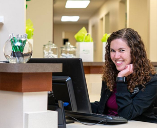 Team member smiling at patient visiting for restorative dentistry