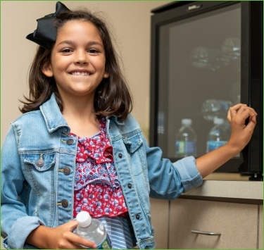 Smiling young girl in dental office from family dentistry visit
