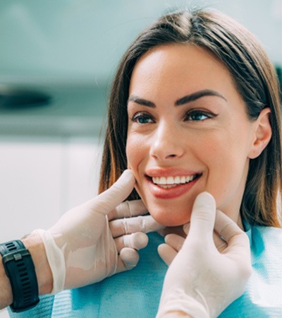 Smiling woman flossing after professional Zoom! teeth whitening in Sugarcreek Township