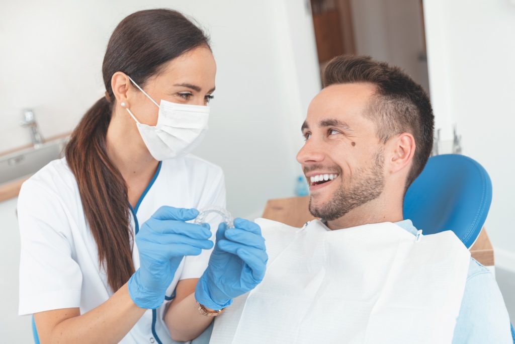 Invisalign provider and patient smiling at consultation