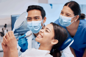 a patient visiting her dentist and inspecting her smile